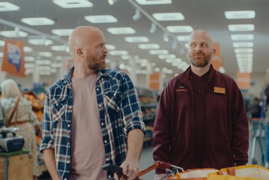 Two identical men looking at each other in a Sainsbury's store